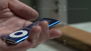 Male hands connect the headphones to ipod, music player, mp3 player . Pair of headphones in the hand screenshot 4