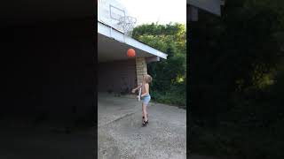 Boy attempts to shoot basketball at hoop but ball hits awning of house then bounces back hits head