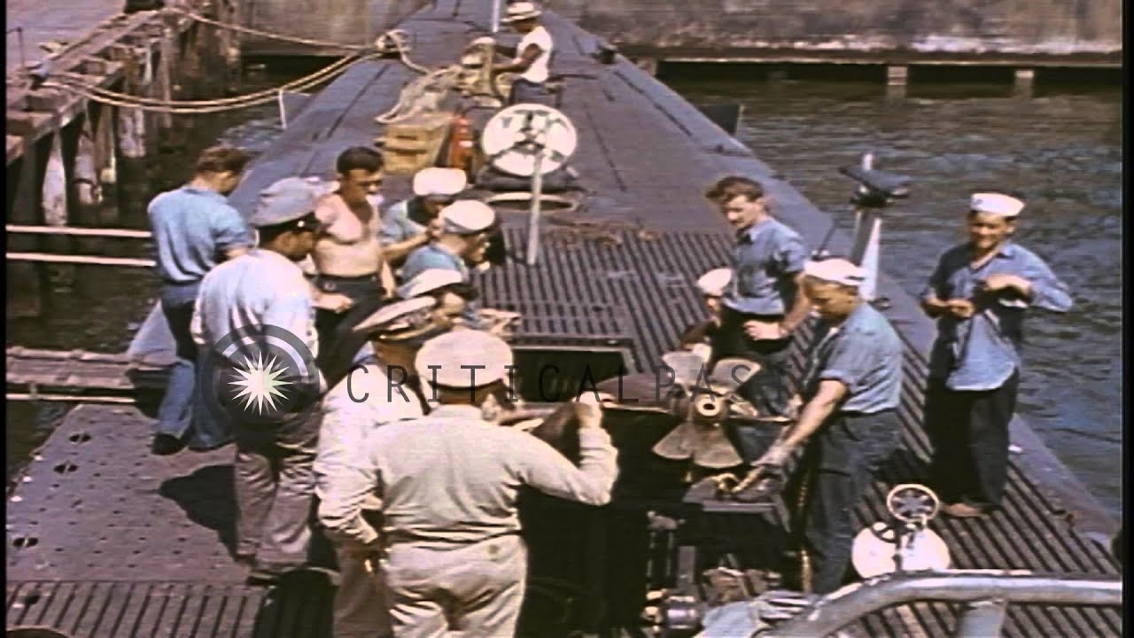 The torpedo being loaded and signalman clears search light on a ...