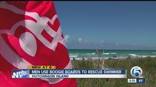 Men use boogie boards to rescue swimmer