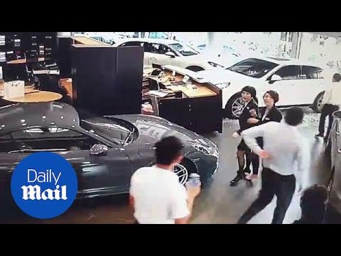 Moment furious businessman crashes Porsche into dealership - Daily Mail