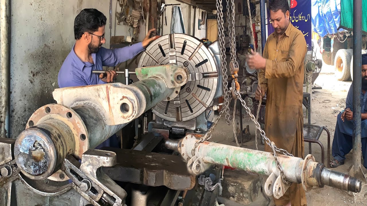 Hardworking Mechanist are Repairing Axle Shaft How Truck Rear Axle