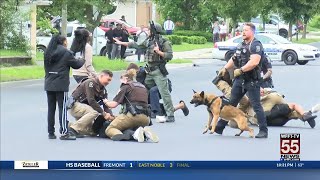 Standoff ends with suspect arrested, fight breaking out in street with cops and onlookers