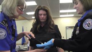 TSA agent in training patting down a woman, demonstrating how to pat down breast and private parts screenshot 3