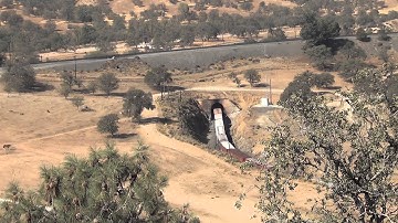 Union Pacific mixed freight train exits tunnel @ Tehachapi loop and climbs over self  10/18/14