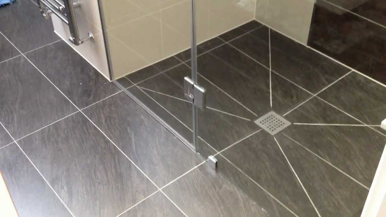 Bespoke glass shower enclosure with hinged door.