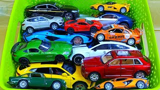 Box full of various miniature cars Jaguar, Renault, Peugeot, Maserati, BYD, Lotus, Volkswagen 34