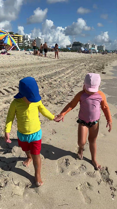 Toddlers Naomi and David are strolling along the beach. Cute Kids Walking!