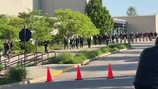 Sheriff's deputies make their way to the Cintas Center to honor their fallen deputy, Larry Hender...