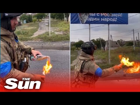Ukrainian Soldier sets fire to Russian billboard with MOLOTOV COCKTAILS near Kharkiv