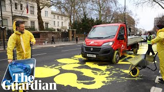 Protesters paint Ukrainian flag outside Russian embassy in London