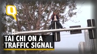 Drunk Man Does Tai Chi Atop A Traffic Light In China