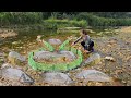 Fishing in the stream using traditional methods. The girl caught a lot of fish.