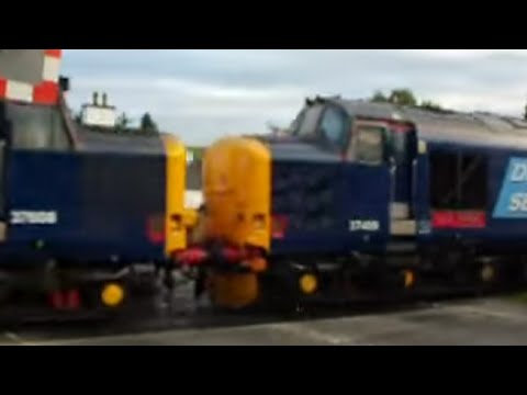 37608 and 37409 pass over a level crossing in Dingwall