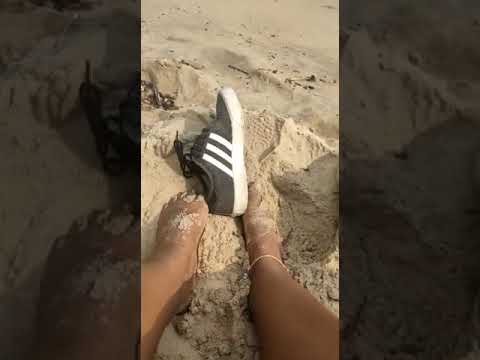 Miih Taking Off Shoes On The Beach