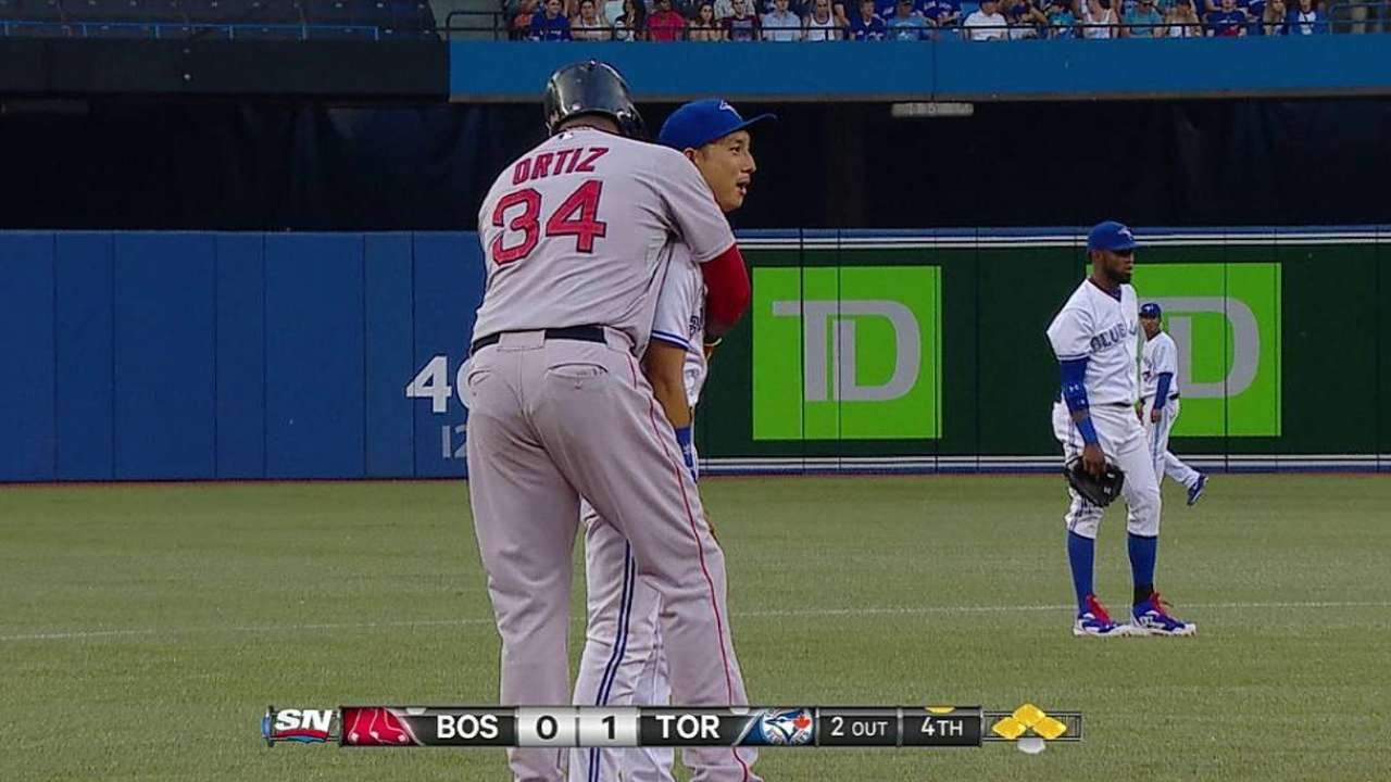 Munenori Kawasaki leads Cubs players (wearing headbands) in an