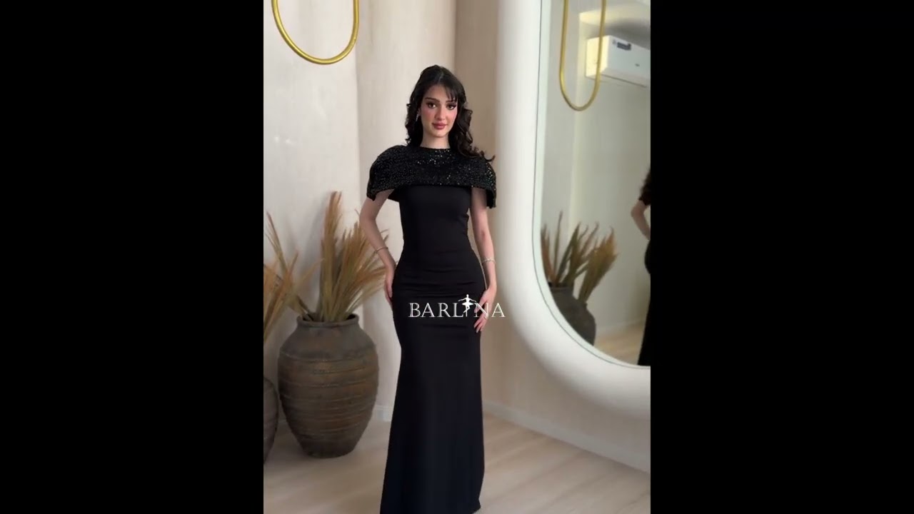 Classic black dress with a short sequined cape