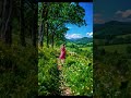 A woman is running along a narrow path through a beautiful countryside. #shortvideo #aivideo