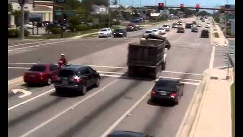 Dump Truck runs red light and performs craziest swerve away from car