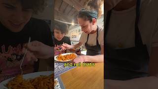 Cutting Pasta With Scissors In Front Of Italians