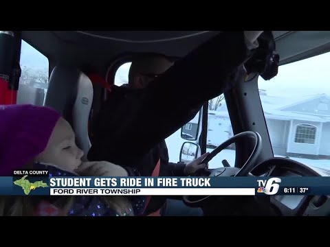 Webster Kindergarten Center student rides to school in fire truck