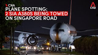 Two Singapore Airlines Airbus A380 planes being towed on Singapore road