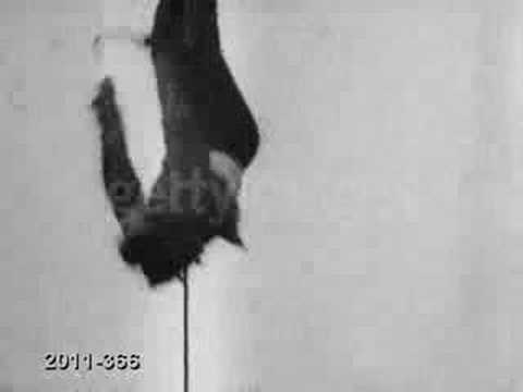 A film of Harry Houdini escaping from a straitjacket while hanging upside down.