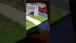 Boy rides bike on sidewalk and crashes into red Pickup Truck parked in driveway
