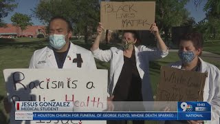 Medical students at Burrell College hold #WhiteCoatsForBlackLives