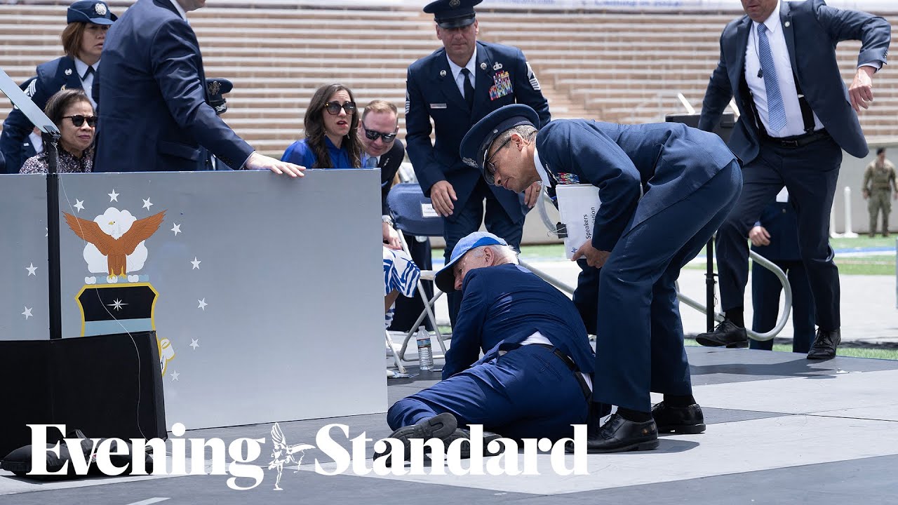 Moment Joe Biden falls over after speech to US air force academy graduates