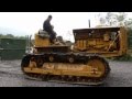 Caterpillar d8 bulldozer pulling huge tree