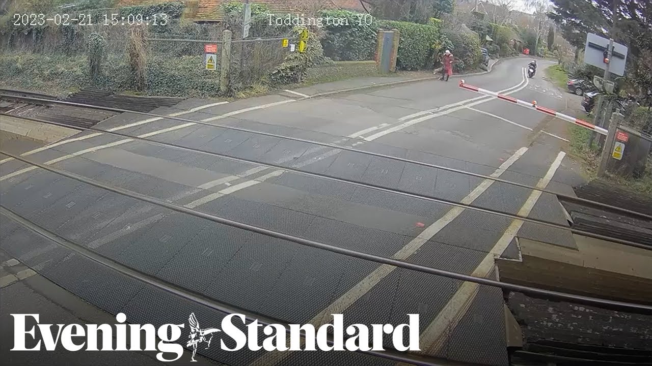 Moped narrowly avoids 70mph train at level crossing