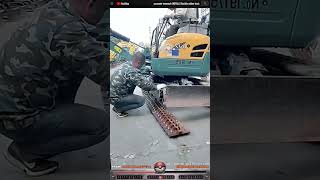 Excavator teamwork INSTALLS flexible rubber track