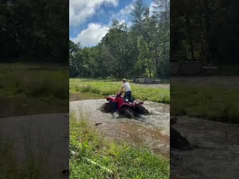 Riding four wheeler through creek