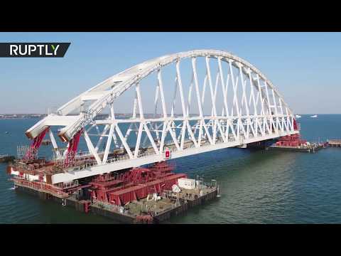 Russia installs Crimea bridge railway arch in 'unique operation' (DRONE FOOTAGE)