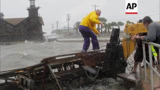 Slow-moving Tropical Storm Debby's outer bands lashed Florida with rain and kicked up rough surf off