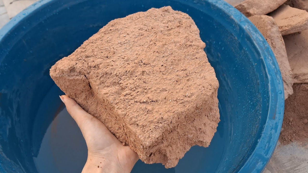 New video Soft red dirt water crumbling satisfying