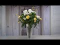 Yellow &amp; white roses into a cut glass vase