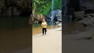 Baby Walking In Front Of Waterfall