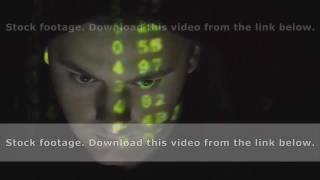 Source code projected over an angry hostile man's face, black background.