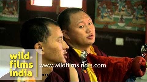 Monks blowing large Monastery trumpets