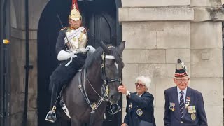 A Beautiful moment kings guard moves his horse so a veteran couple can get a photo together with him