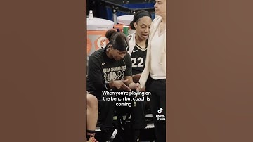 Syd Colson and Aja Wilson dancing on the bench!