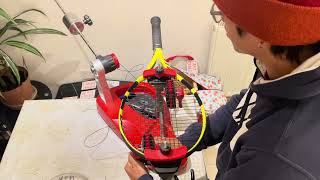 Racket restringing with drop weights.