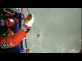 HM Coastguard winchman Niall Hanson is lowered onto the Kuzma Minin after it ran aground
