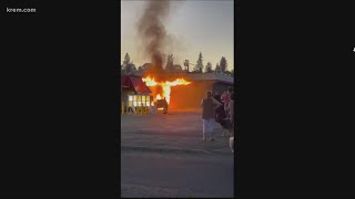 Car fire catches pawn shop on fire in North Spokane