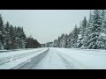 point of view   driving on wintry snowy highway in northern Sweden