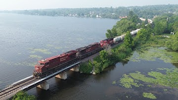 Awesome Aerial 4K View! Long Train CPKC 120 passing Lake Magog at Deaville, Quebec near Sherbrooke