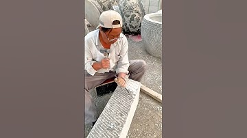 Carving Detailed Patterns on a Stone Block with Hammer and Chisel