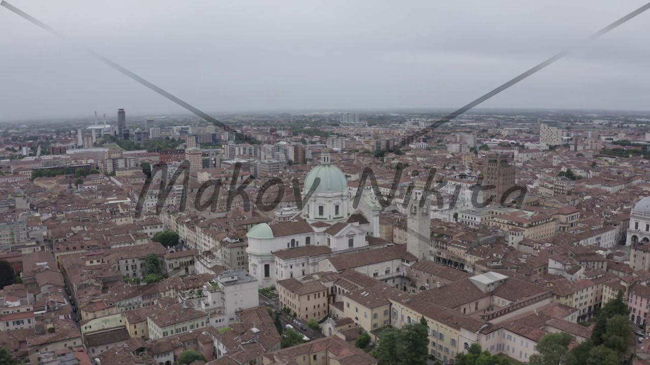 D-Log. Brescia, Italy. Cathedral of Santa Maria Assunta. Flight over the city in cloudy weather, Ae